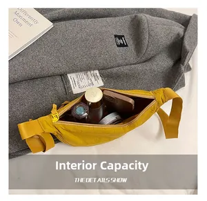 Detail view of large internal capacity showing phone and makeup in yellow nylon bag