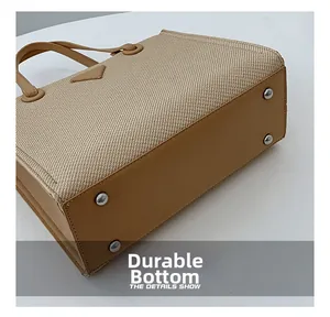 Macro view of woven tote bag with durable leather bottom and protective silver studs