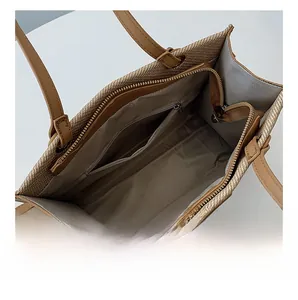 Spacious woven tote interior featuring a zippered pocket and large capacity storage