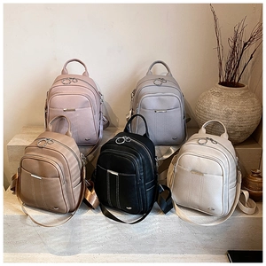 Close-up of stylish leather backpacks in five colors with premium textured finish