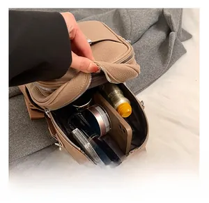Interior detail of light brown pebbled leather backpack showing main compartment capacity