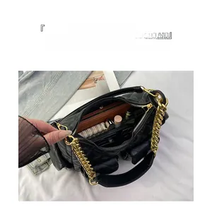 Detail of the large capacity quilted chain bag showing organized interior storage