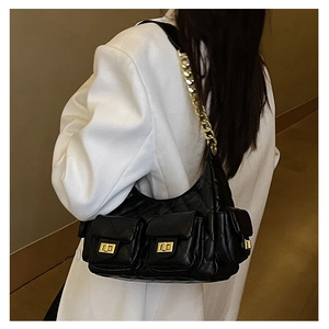 Black quilted hobo bag with gold chain and multiple pockets shown on model