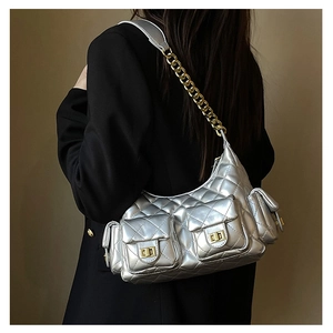 Detail view of silver quilted shoulder bag with multi-pockets and gold chain strap