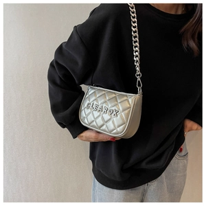 Detailed macro of silver quilted crossbody bag with CLEAR OK logo and chunky chain strap