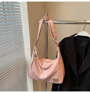 Pink hobo shoulder bag featuring retro washed texture and woven rope detail