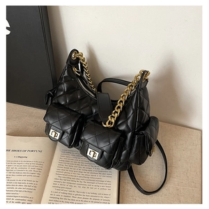 Detail of black quilted shoulder bag featuring gold twist-lock multi-pocket design