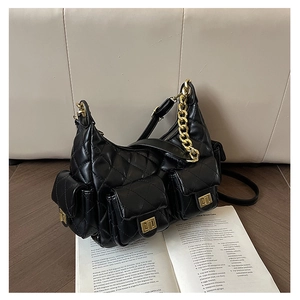 Close-up of black quilted leather shoulder bag with gold chain and multi-pocket design