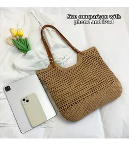 Detail of woven beach tote with brown PU leather handles and size comparison to tablet