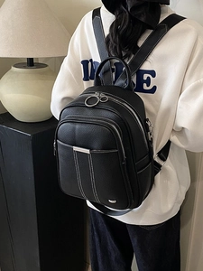 Fashionable black pebbled PU leather backpack with multiple zippers and silver hardware