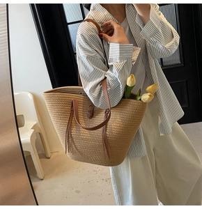Straw tote bag detail with leather handles and interior view featuring tulip decoration