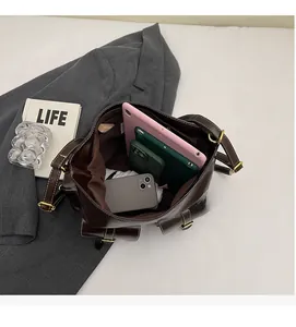 Internal view of a brown vintage tote bag showing large capacity for tablets and phones