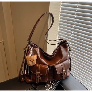 Detail view of large retro tote bag with dual front pockets and adjustable strap