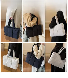 Quilted tote bag detail showing large grid stitching and thick shoulder straps