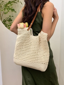 Handmade hollow crochet tote bag with brown leather handles for summer beach vacations
