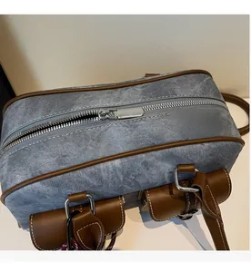 Detail of silver smooth zipper and denim fabric on a vintage Boston bag