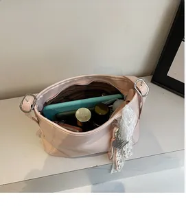 Top view of pink bucket bag showing large interior storage for tablet and cosmetics
