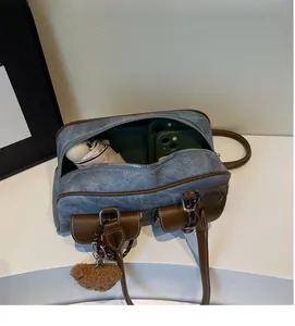 Internal view of denim Boston bag showing spacious capacity for phone and umbrella