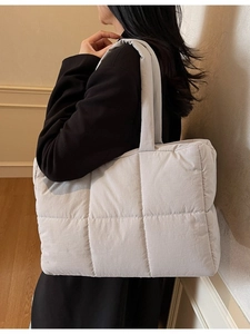 Light gray quilted tote bag for women featuring large capacity and a stylish padded design