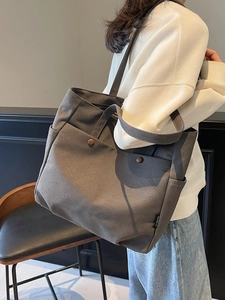 Deep grey canvas tote bag for women featuring front dual pockets and reinforced shoulder straps