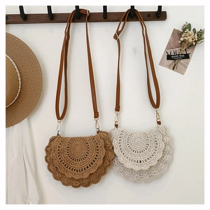 Detail of bohemian hand-woven crossbody bags with leather straps and hollow patterns