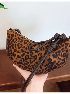 Leopard print croissant shoulder bag with brown knotted leather strap and metal zipper