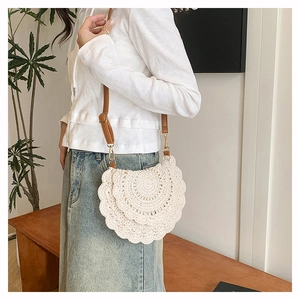 Detailed macro view of bohemian hand-woven crochet bag with premium brown leather strap
