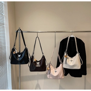 Detail view of stylish tote bags in four colors hanging on a modern metal clothing rack