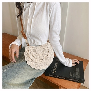 Close-up of bohemian ivory crochet crossbody bag with detailed handmade wavy textures