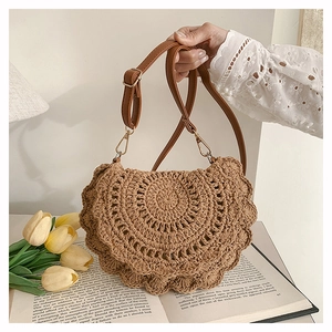 Detail of bohemian hand-woven bag featuring petal-shaped edges and leather shoulder strap