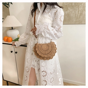 Detail view of Bohemian crochet crossbody bag with scalloped edges and woven texture