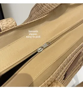 Detail of smooth metal zipper and fabric lining on a handmade straw tote bag