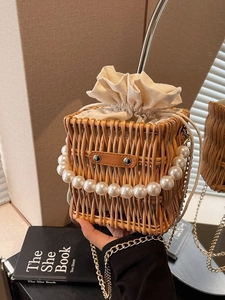 Handwoven straw bucket bag with pearl handle and metallic chain strap for women