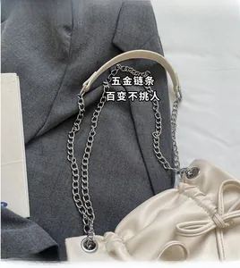 Detail view of the cream bow shoulder bag with drawstring pleats and silver chain strap