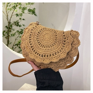 Detail shot of a bohemian hand-woven crescent bag featuring intricate hollow-out texture