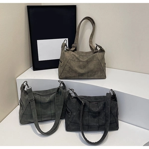 Detailed grid-stitched matte leather tote bags shown in khaki, dark gray, and black colors