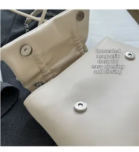Detail of off-white leather bag with hidden double magnetic buckles for easy closure