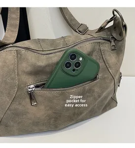 Detail view of the gray vintage tote bag featuring a functional side zipper pocket for phone