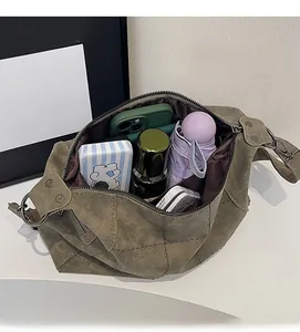 Top view of spacious interior of dark green tote bag showing organized daily essentials