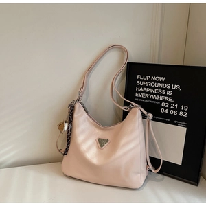 Detail of light pink hobo tote bag with silk scarf and triangular metal logo