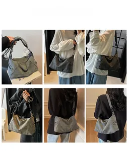 Detail view of large matte shoulder bags showing grid stitching and adjustable straps