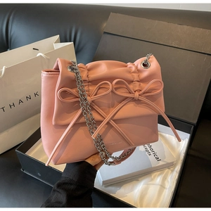 Detail of pink chain bag with double bows in a luxury gift box setting