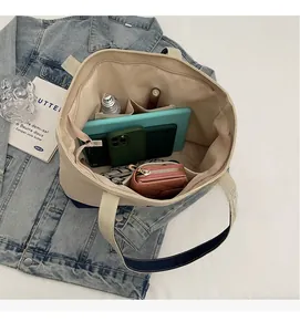 Spacious canvas tote bag interior showing capacity for tablet, wallet, and cosmetics