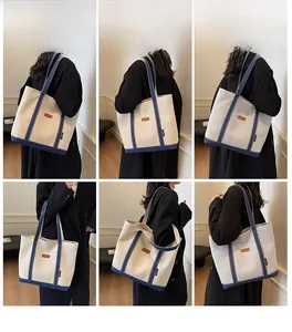 Large cream canvas tote bag with navy blue straps shown from multiple angles