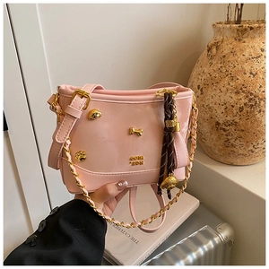 Pink glossy tote bag featuring gold bone and cat-shaped charms with chain strap