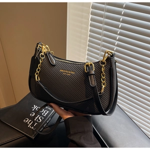 Detail of black woven leather shoulder bag with gold chain and dual strap design
