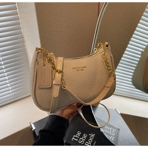 Detailed close-up of beige textured hobo bag with gold chain and leather strap