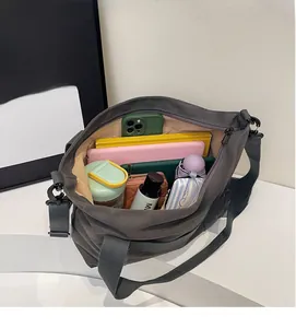 Large gray canvas tote bag interior showing capacity for laptop, umbrella and daily essentials