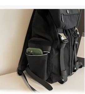 Gros plan d'une poche latérale zippée sur un sac à dos en nylon noir multifonction