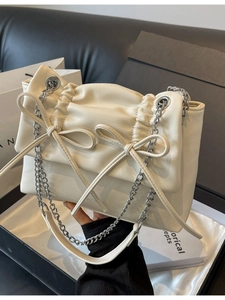 Chic beige bow chain crossbody bag with elegant ruched details and glossy finish